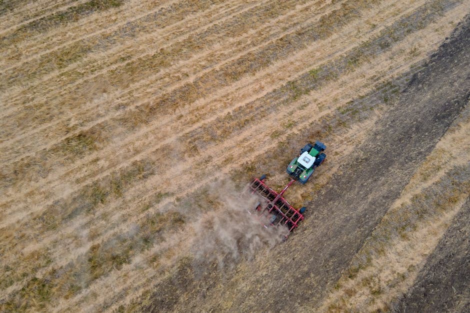 Tractor plowing a field with GPS guidance